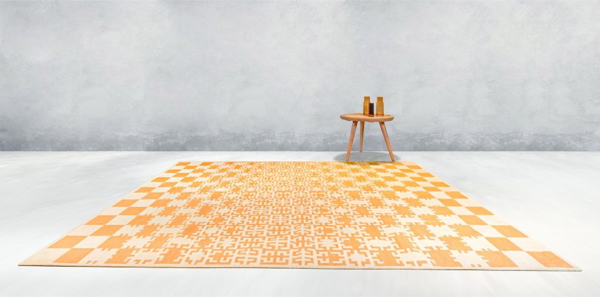 Yellow and off white gridded rug on grey backdrop