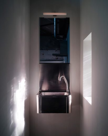 Stainless steel sink in a narrow bathroom