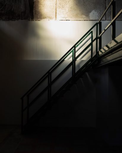 Close-up shot of green metal staircase