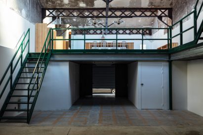 Mezzanine with green staircase by The Guild of Saint Luke