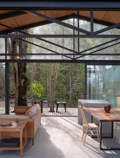 Interior living space and large sliding doors at Quilanto House by Hebra Arquitectos
