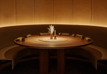 Large round wooden table inside Ikoyi restaurant