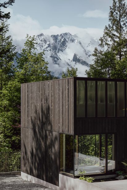 Blackened timber cladding on rectilinear Canadian house by Leckie Studio