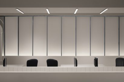 Tops of chairs visible behind tiled partition walls