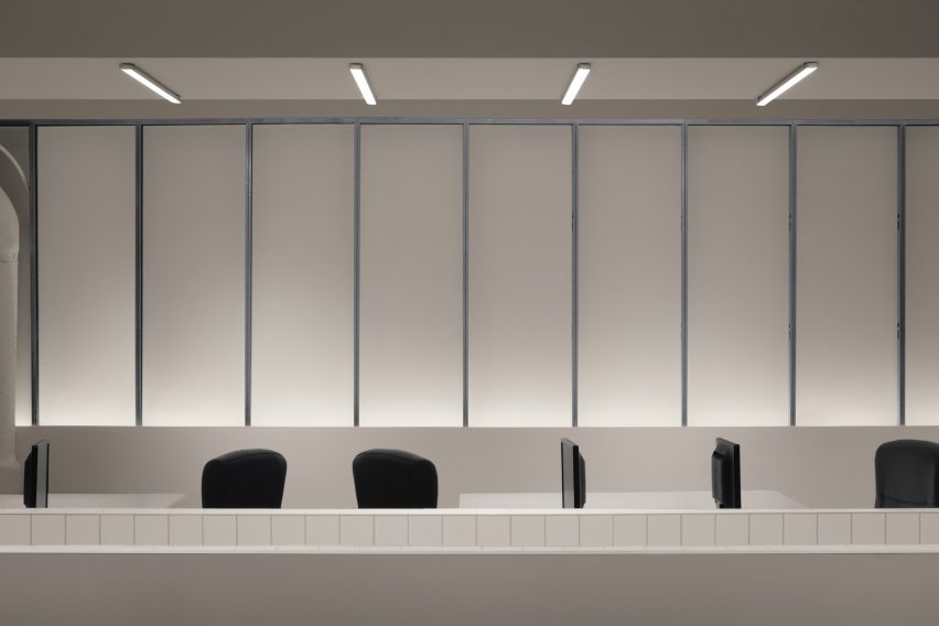 Tops of chairs visible behind tiled partition walls