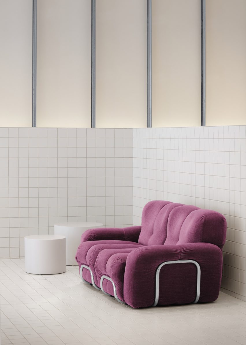 White tiled space with purple sofa