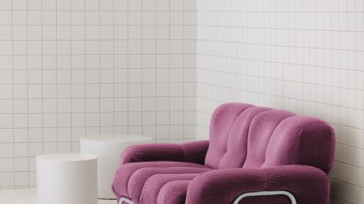 White tiled space with purple sofa