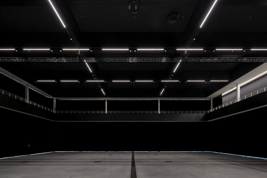 Photograph of interior showing vast function hall with black curtains closed