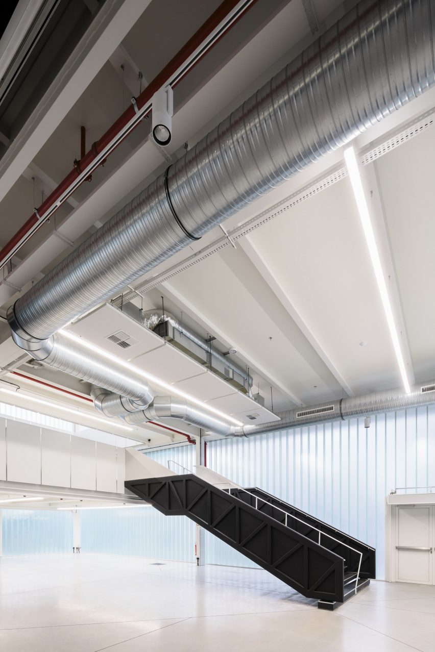 Photograph of staircase showing services on ceiling