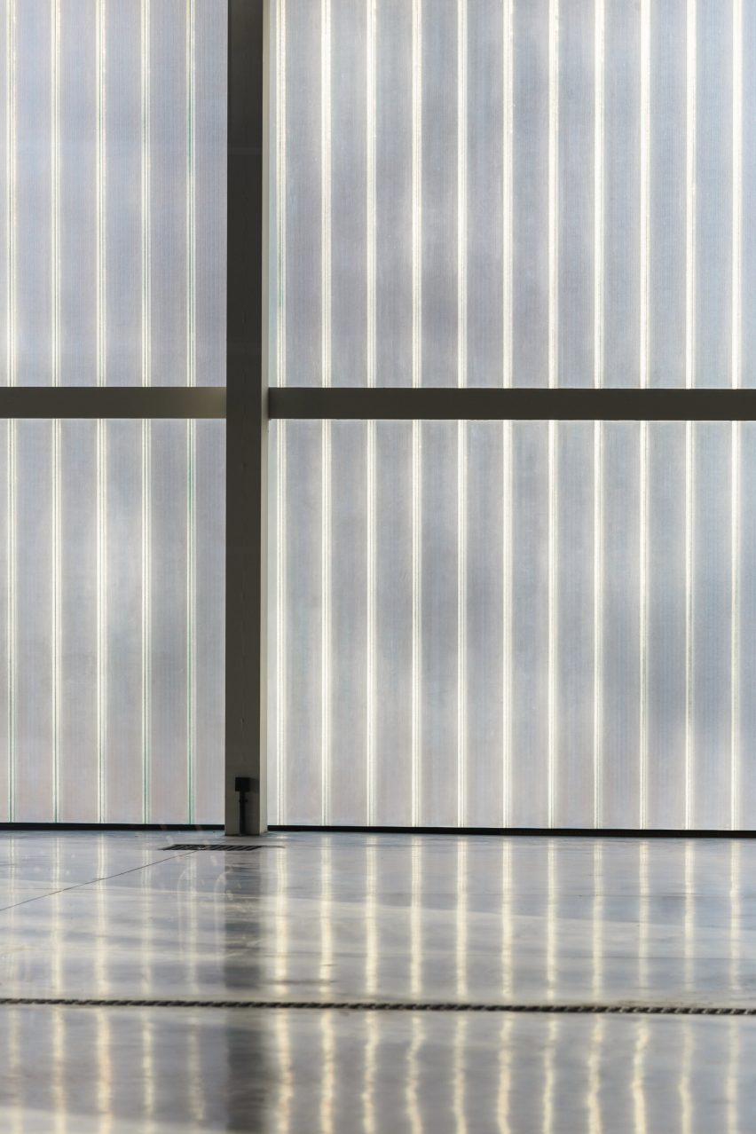 Photograph of translucent wall detail reflecting off of flooring