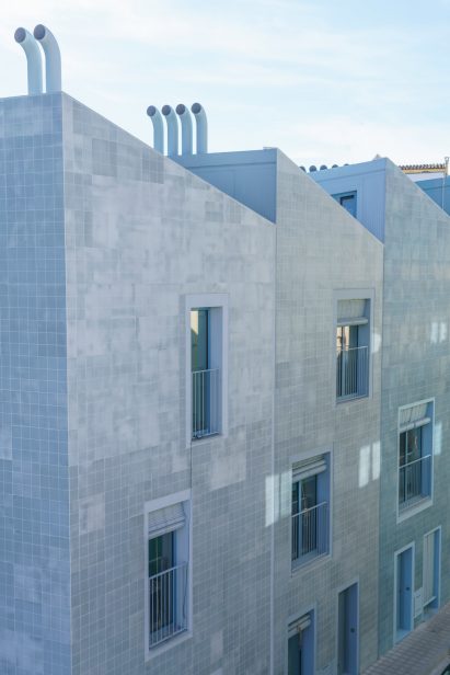 Las Fabri-Casas featuring blue tile facade and saw-tooth roof