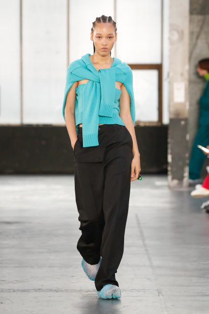 A model wearing a Reebok x Botter Sneaker