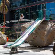 Child next to playground made from rock