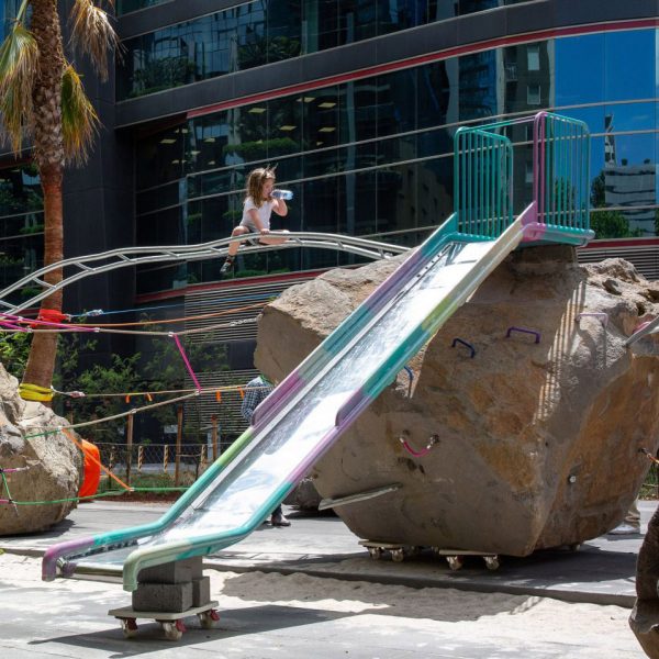 Child next to playground made from rock