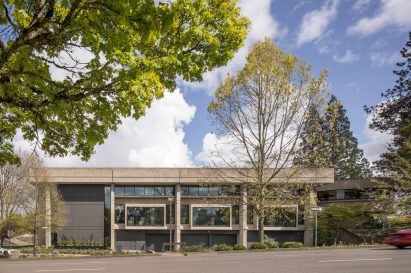 Rectilinear brutalist library building with large windows on its facade