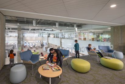 Youth space within glass enclosure with carpets in the Salem Public Library