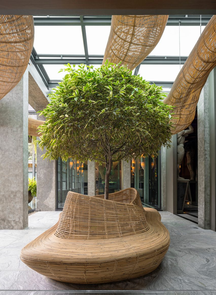 Meandering rattan structure around a courtyard tree by Enter Projects Asia