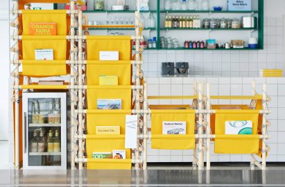 Close-up photo on the yellow fabric racks with each pocket holding a different book about design, architecture, culture or the environment