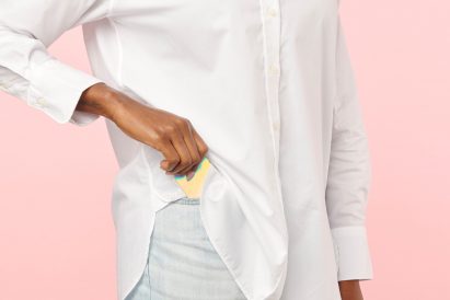 Person taking iridescent playing card out of pocket