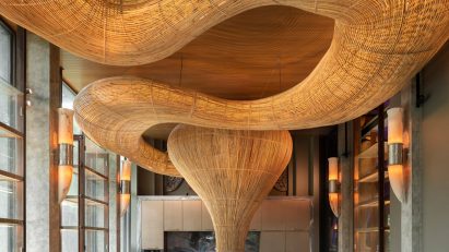 Meandering rattan structure in a dining room by Enter Projects Asia