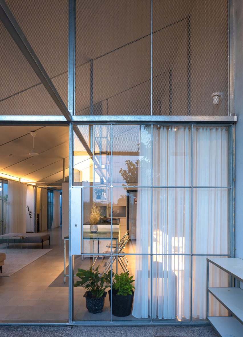 Glazed front entrance of a steel-structure home by MIA Design Studio