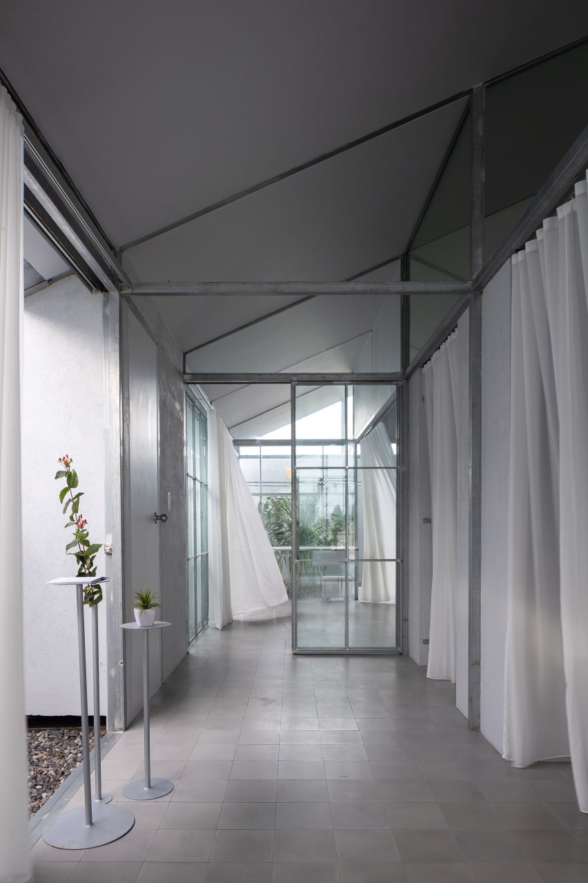 Mono-pitched hallway with a steel structure and white curtains
