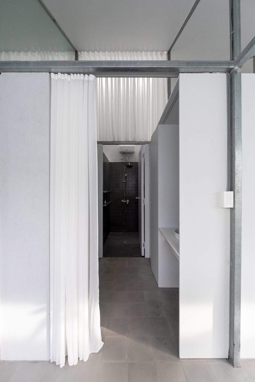 Hallway in a home with a steel structure and white curtains