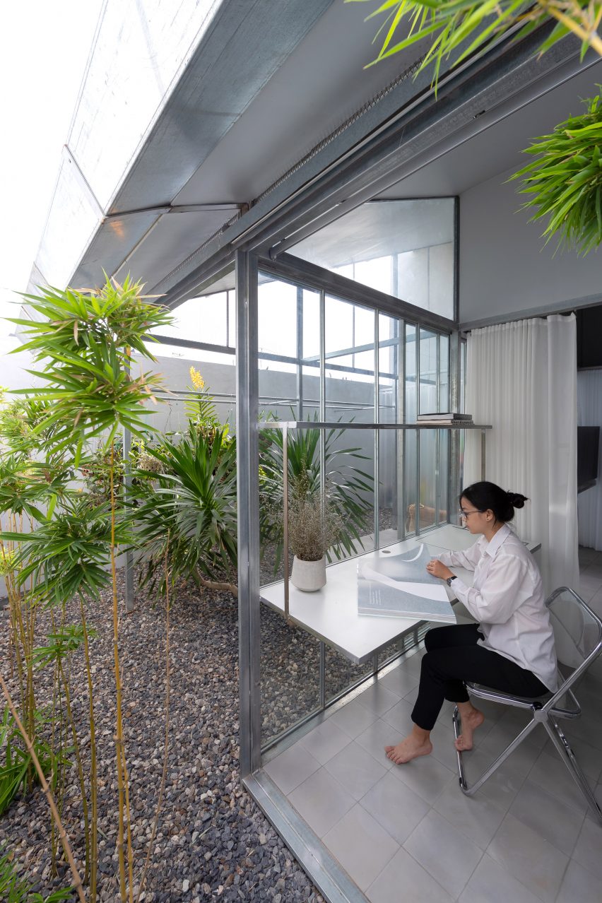 Office study space in a steel structure home overlooking an outdoor courtyard