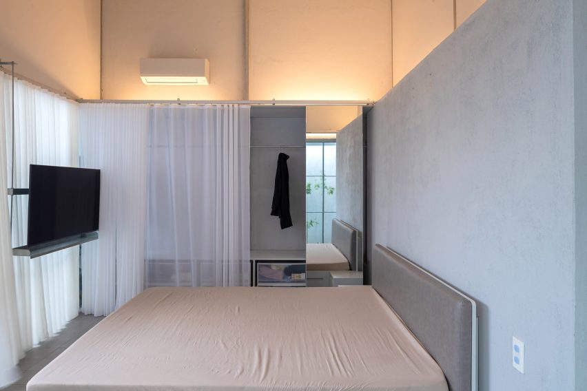 Grey bedroom with white curtain room divider