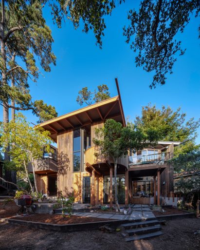 Exterior of home with overhanging roofs and circular terrace