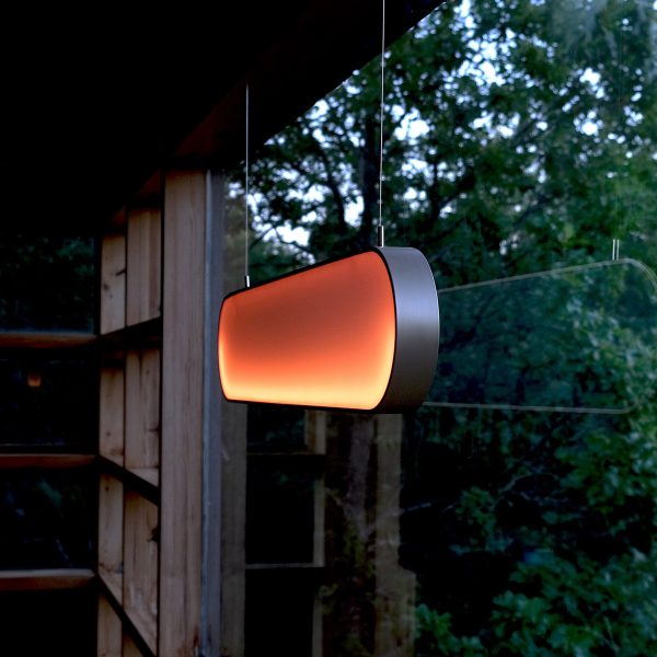 Glowing orange lamp hung in window