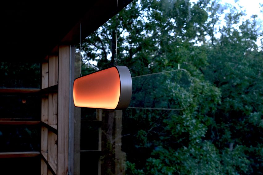 Glowing orange lamp hung in window