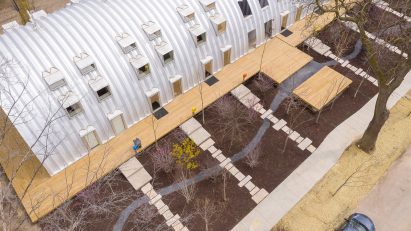 Aerial view of a scattering of trees outside the Caterpillar apartment building