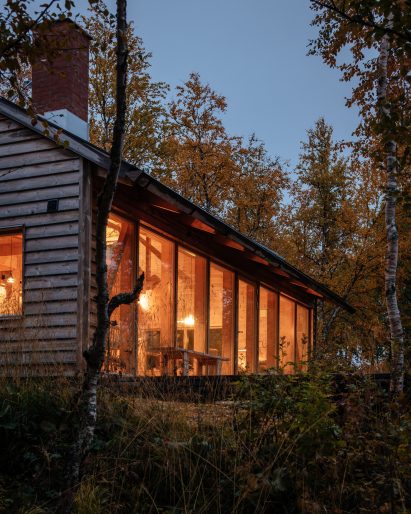 Exterior image of The Hat House lit at dusk