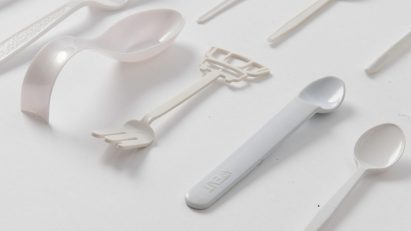 Picture of white plastic spoons on a white backdrop used to illustrate story about UK's ban on single-use plastic tableware