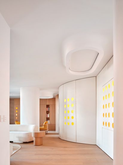 White structural walls with yellow openings snaking round first floor of Unit 1040 apartment
