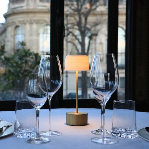 Lamp on dining table with wine glasses