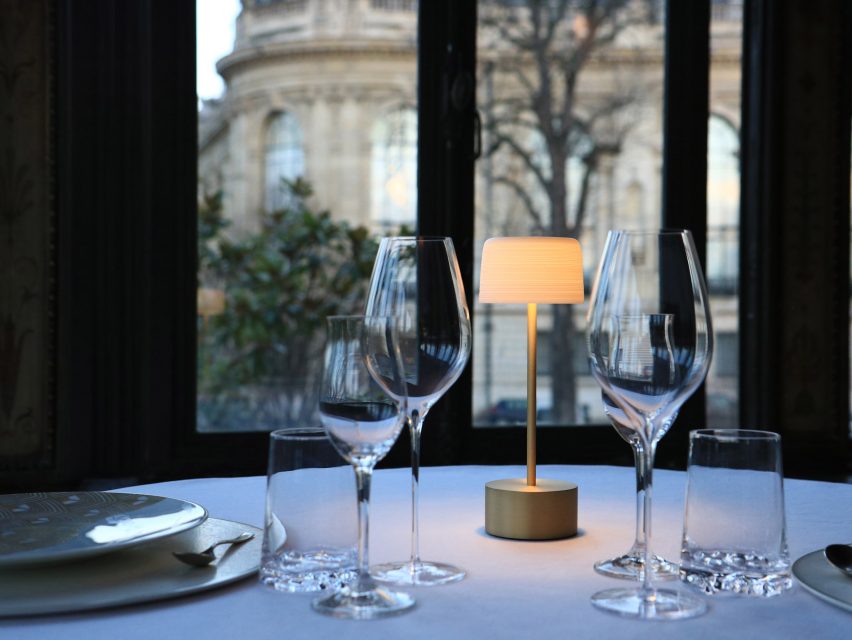 Lamp on dining table with wine glasses