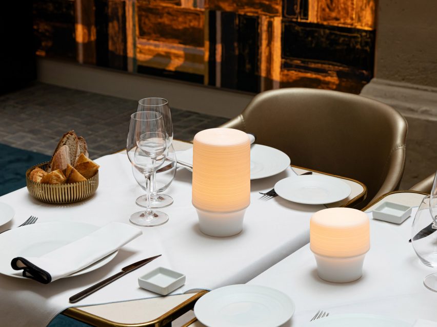 Lamp on dining table with wine glasses and table settings
