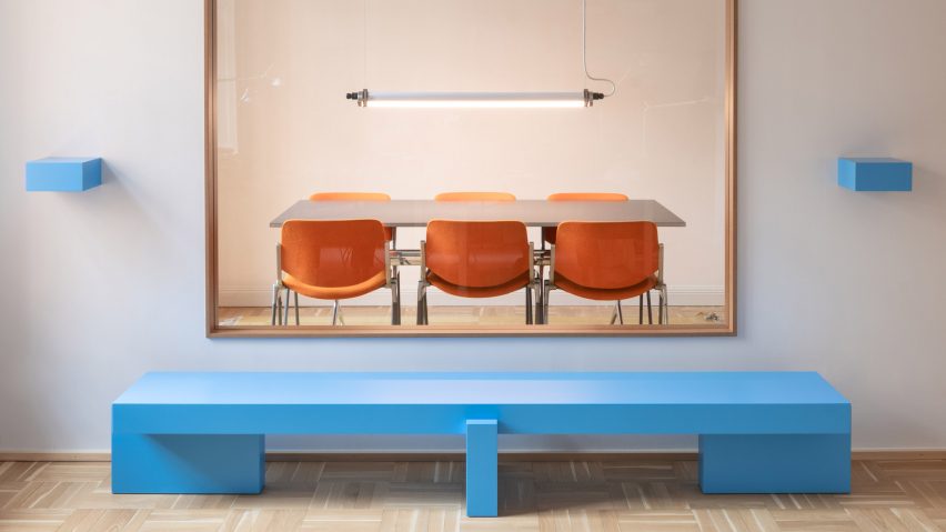 Sky blue sideboard in front of interior window with blue shelves either side