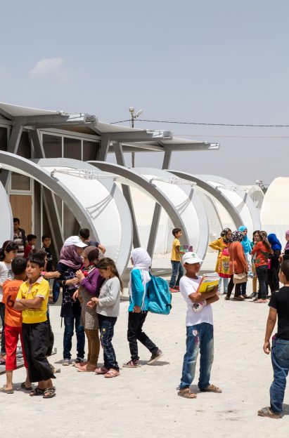 Children playing in front of refugee tent 