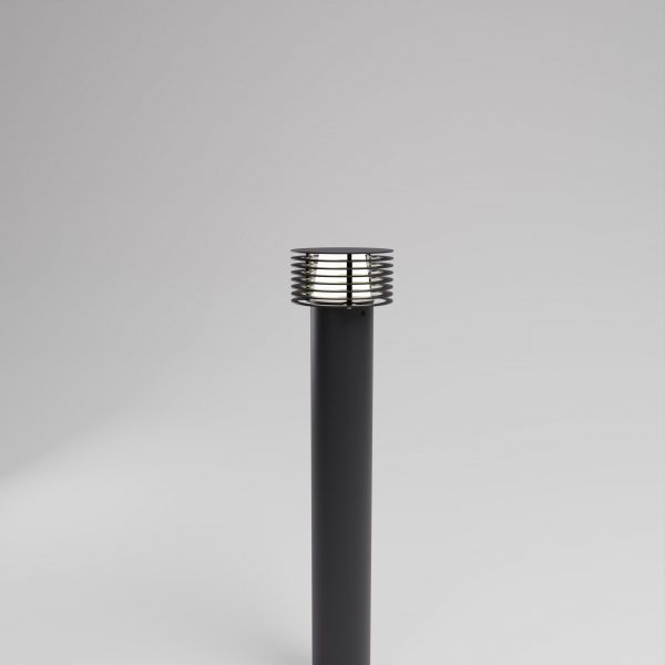 Black bollard on grey backdrop with slatted shade