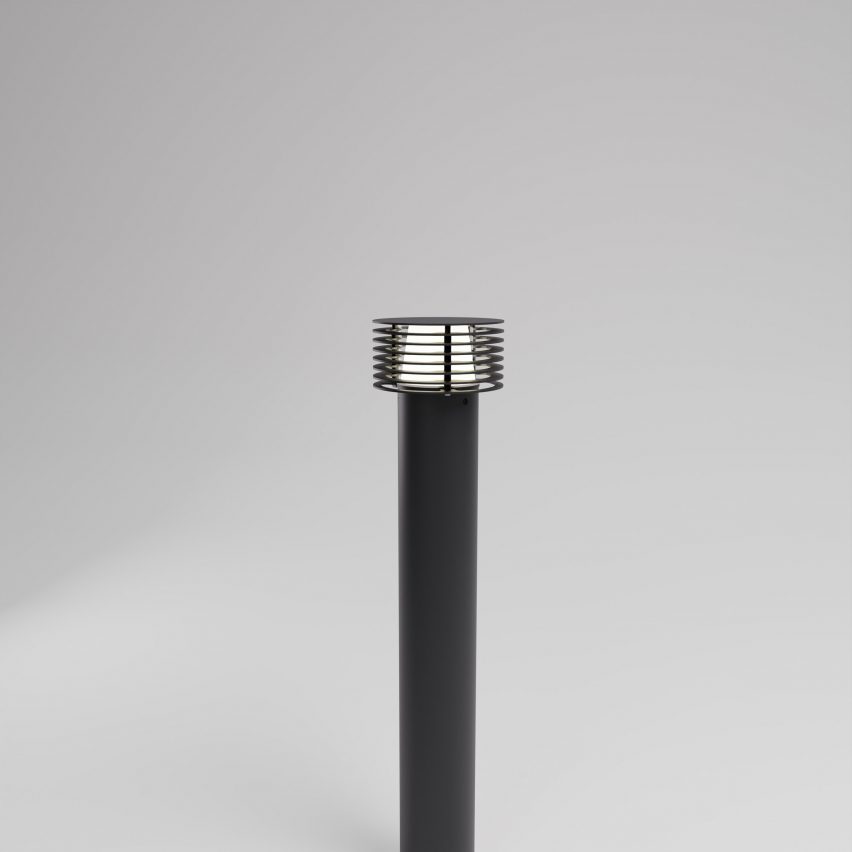 Black bollard on grey backdrop with slatted shade