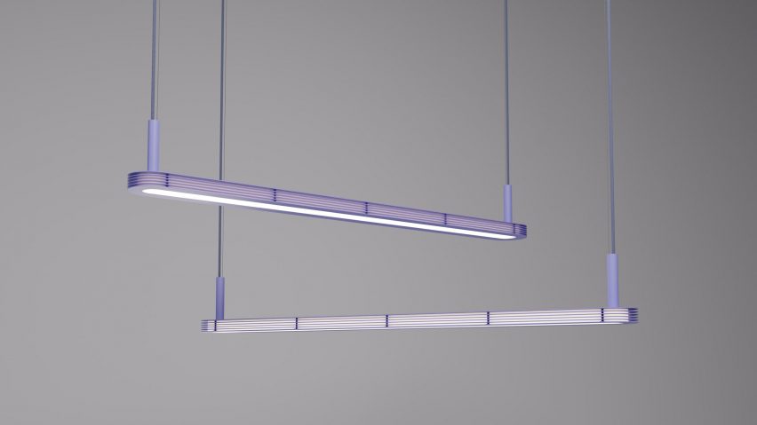 Purple long pendant light suspended in front of grey background