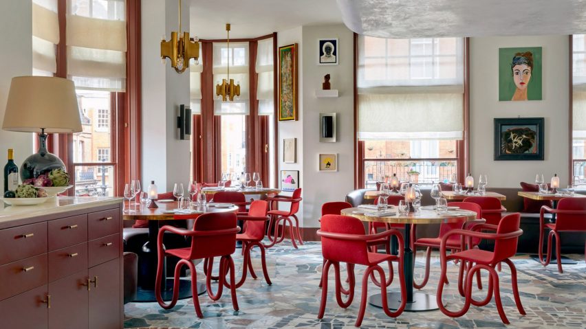 Audley pub in Mayfair, London, which features red chairs and art on its walls