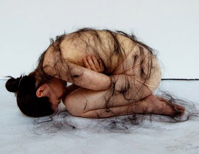 Photography project where woman has long black hair draped over her