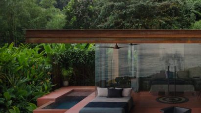 Floating villa of red rammed-earth in Coast Rica jungle by Formafatal