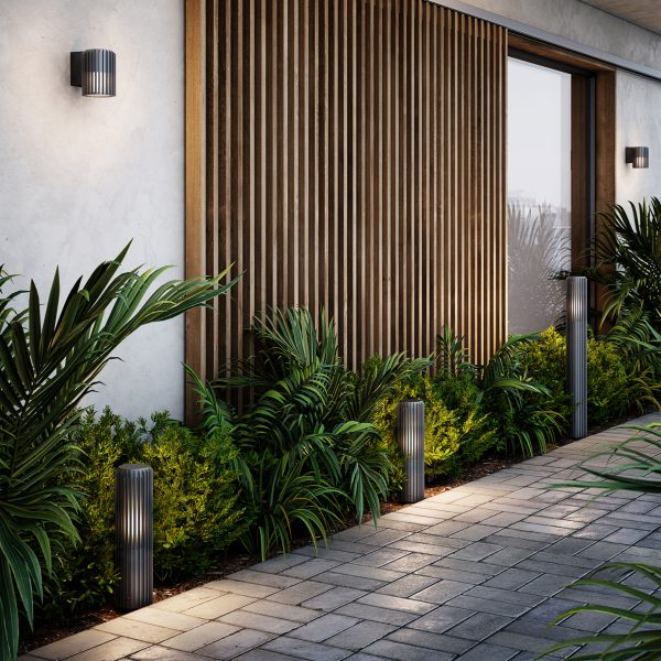 Aludra garden lighting and wall light in an outdoor area with square tiles and planted edge