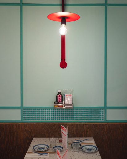 Wood-lined seating booth in Paris restaurant by Atelieramo
