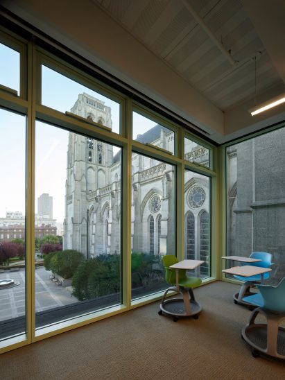 Interior working space with glazed walls overlooking a catherdral